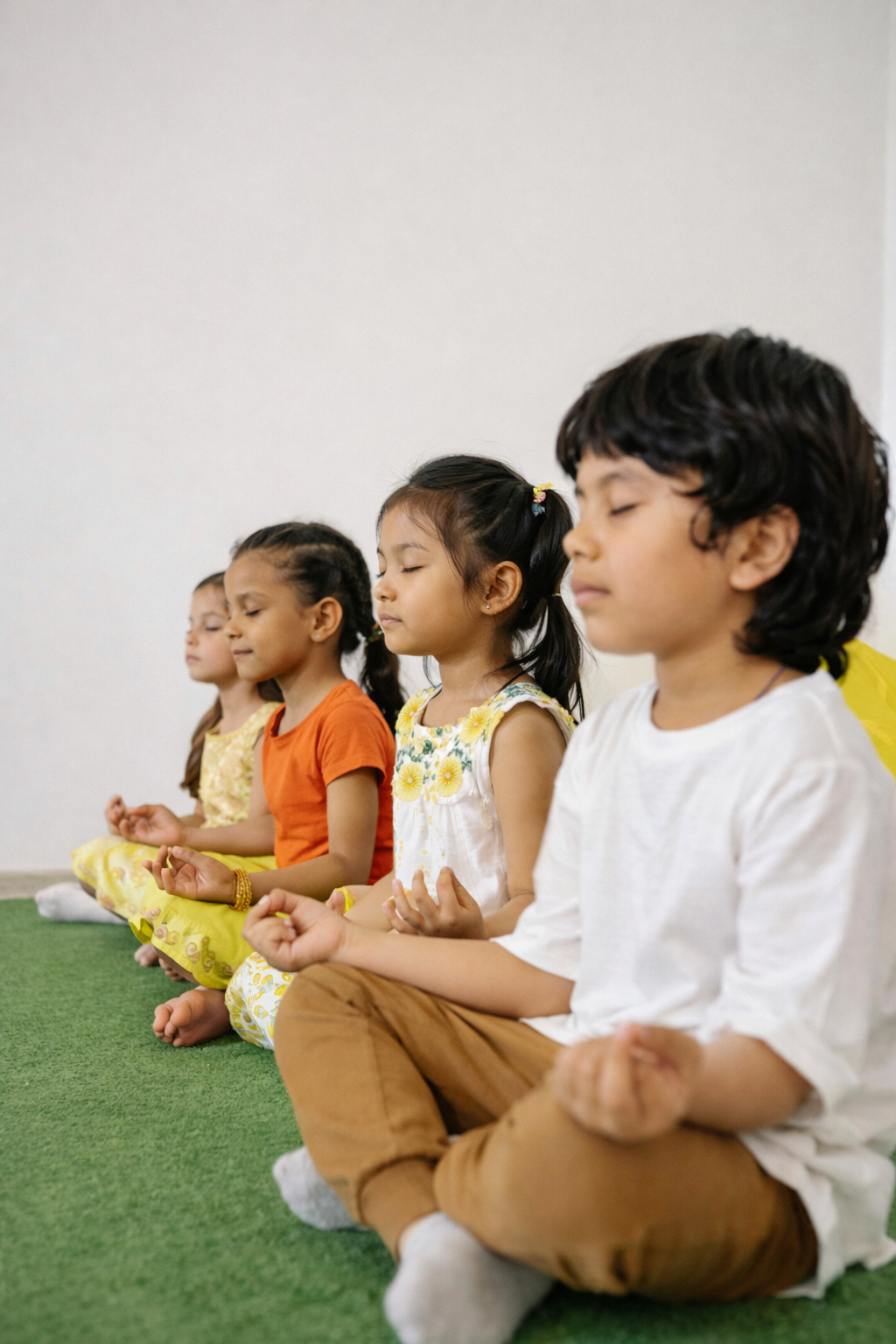 Children practicing yoga in a colorful studio